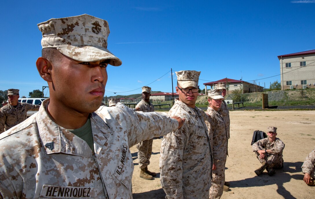 Cpl Victor Henriquez, an air traffic control radar technician with Marine Air Control Squadron 1, demonstrates what to do in a uniform inspection formation during a Committed and Engaged Leadership Indoctrination course aboard Marine Corps Base Camp Pendleton, Calif., April 1-3. During the three-day course, some periods of instruction included uniform inspections, how to lead guided discussions, communications and counseling, and an introduction to the NCO Creed.
