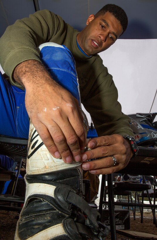 Lance Cpl. Anastacio Henry, a consolidated automatic support systems technician with Marine Aviation Logistics Squadron 11, snaps on riding boots during an American Supercamp Riding School course aboard Marine Corps Air Station Miramar, Calif., April 1-2. The school provided dirt bikes and riding gear for Marines to train with so they can fully focus on gaining knowledge without worrying about sacrificing their own gear.