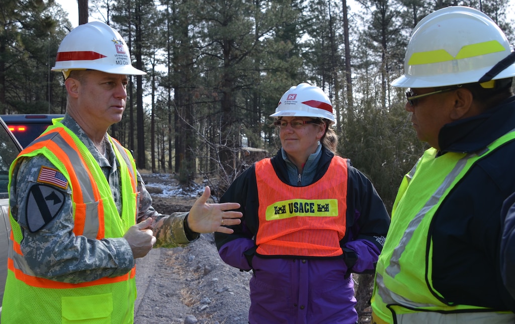 SANTA CLARA PUEBLO, N.M., -- Maj. Gen. Kendall P. Cox, Deputy Commanding General, Military and International Operations, Headquarters, U.S. Army Corps of Engineers, (left), toured Santa Clara Pueblo, March 27, 2014. He discussed the devastation that occurred on Pueblo lands with Sheriff Regis Chavarria, Santa Clara Pueblo, and Tamara Massong, chief, Hydrology and Hydraulics, Albuquerque District, U.S. Corps of Engineers. 