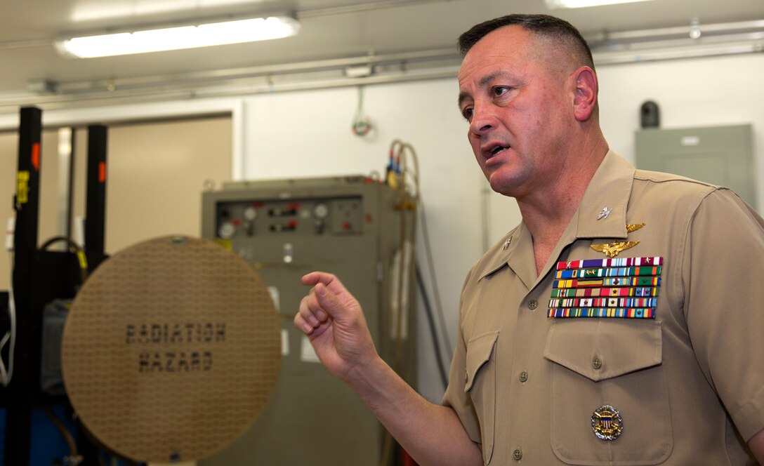 Col. Rick Uribe, Marine Aircraft Group 11 commanding officer, explains the uses of the F/A-18 APG-73 Radar System Integrated Test Bench to a group of officers and senior enlisted personnel during an inauguration ceremony aboard Marine Corps Air Station Miramar, Calif., March 28. The bench will save time, manpower hours and funds for Marines working on the jet’s radar systems by making finding problems easier and more efficient.