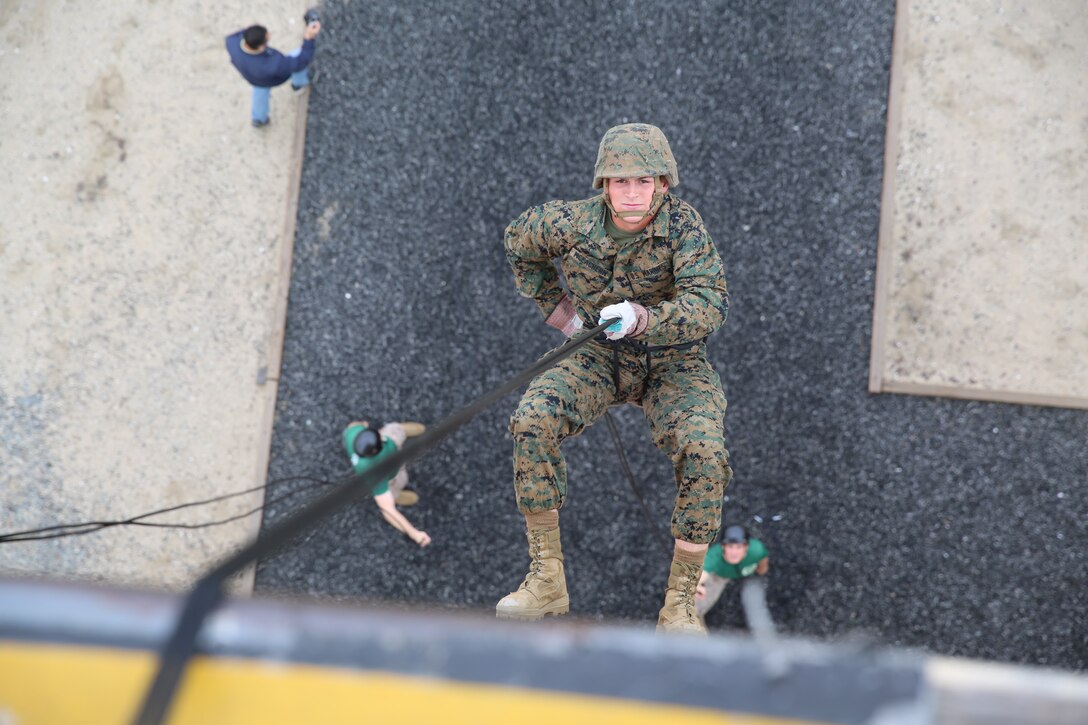 Pvt. Logan R. McEachern, Platoon 1073, Company D, 1st Recruit Training Battalion, back pedals down the rappel tower aboard the depot, March 21. McEachern is described by his drill instructors as one of the hardest working Marines in the platoon.