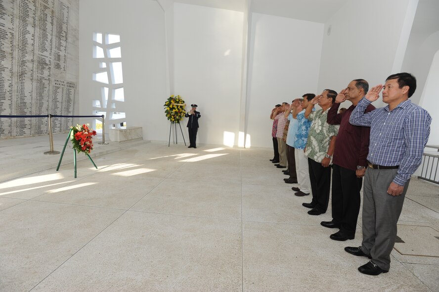 Air Chiefs from several Pacific nations throw flower pedals into the well at the USS Arizona Memorial after a wreath laying ceremony to honor those who lost their lives during the attack of Pearl Harbor. The Air Chiefs are here for the Pacific Air Chief’s Symposium in which they come together to discuss defense, security and international issues throughout the region. (U.S. Air Force photo by Master Sgt. Victoria Boncz)