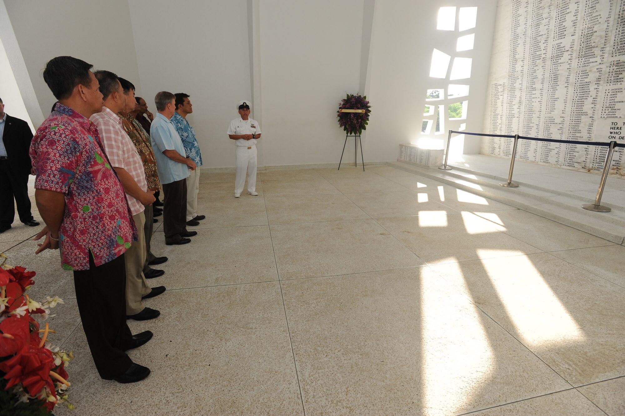 Senior Chief Alex Rincones, Chief of the U.S. Pacific Fleet’s Commander’s barge, explains how the wall at the USS Arizona Memorial lists the names of each crew member who died in the Dec. 7, 1941, attack on Pearl Harbor. The Air Chiefs toured the memorial at Joint Base Pearl Harbor-Hickam March 28, 2014, as part of the Pacific Air Chief’s Symposium. (U.S. Air Force photo by Master Sgt. Victoria Boncz)