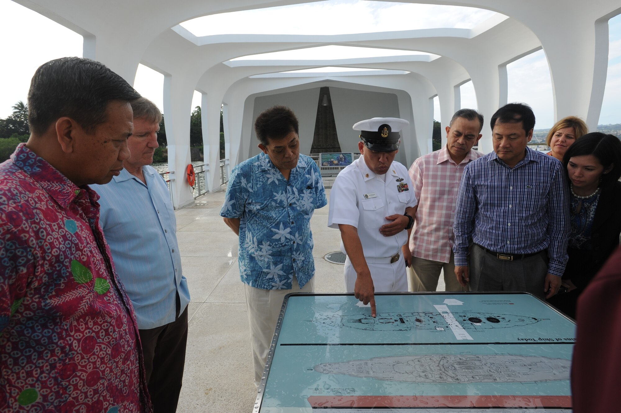 Senior Chief Alex Rincones, Chief of the U.S. Pacific Fleet’s Commander’s barge, points out the areas of the sunken USS Arizona to the attendees of the Pacific Air Chief’s Symposium March 28, 2014, during a tour of the Arizona Memorial at Joint Base Pearl Harbor-Hickam, Hawaii. (U.S. Air Force photo by Master Sgt. Victoria Boncz)