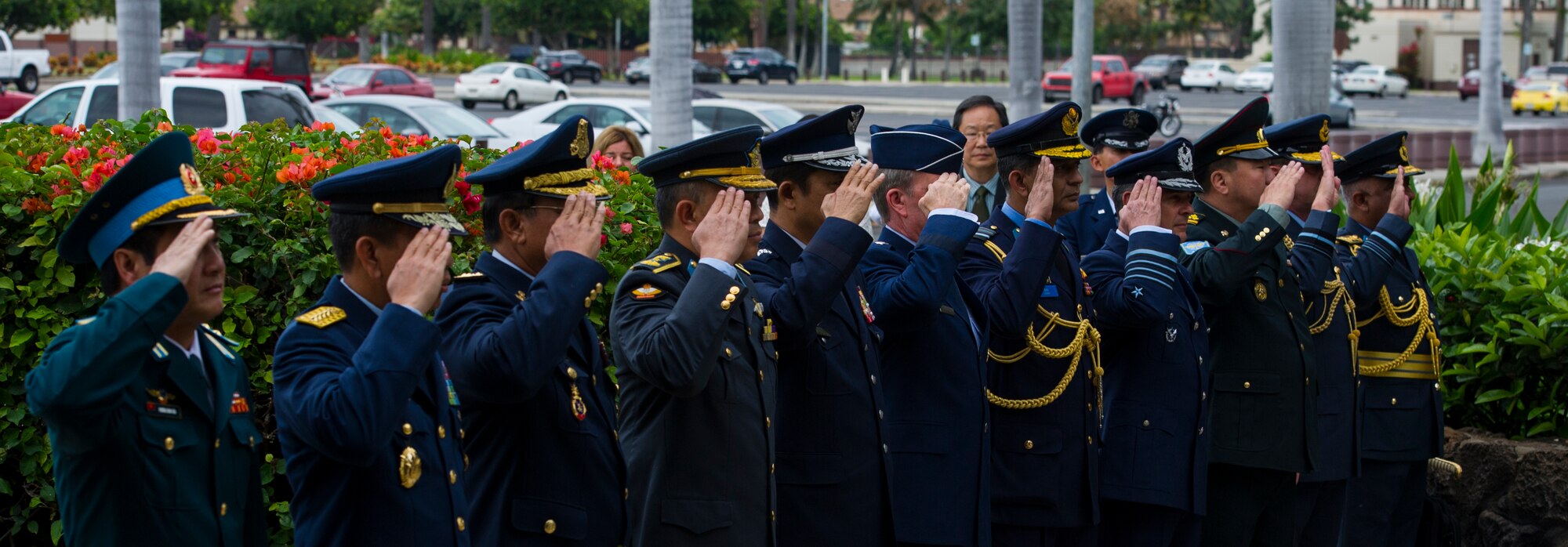 2014 Pacific Air Chiefs' Symposium attendees salute before proceeding through an honor guard cordon outside the Pacific Air Forces Headquarters building March 29, 2014, at Joint Base Pearl Harbor-Hickam, Hawaii. Air Chiefs from various countries including Brunei, Indonesia, Japan, Bangladesh, Cambodia, Mongolia, Vietnam, Chile, Sri Lanka, Nepal, New Zealand, and the U.S. are taking part in the symposium, which began at JBPH-Hickam and will take them to several locations outside Hawaii as well. (U.S. Air Force photo by Staff Sgt. Nathan Allen)