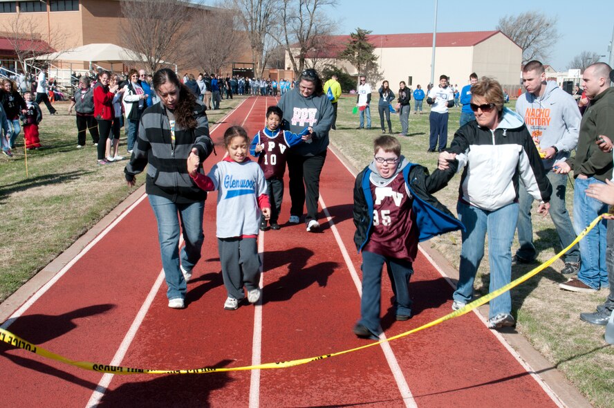 VANCE AIR FORCE BASE, Okla. -- Special Olympians prepare to cross the finish line during a 50-meter dash at the Cherokee Strip Area 6 Special Olympics held here. This year more than 170 Olympians competed at Vance assisted by 200 volunteers from Vance, the Enid High School JROTC and the Oklahoma Bible Academy. (U.S. Air Force photo/Terry Wasson)