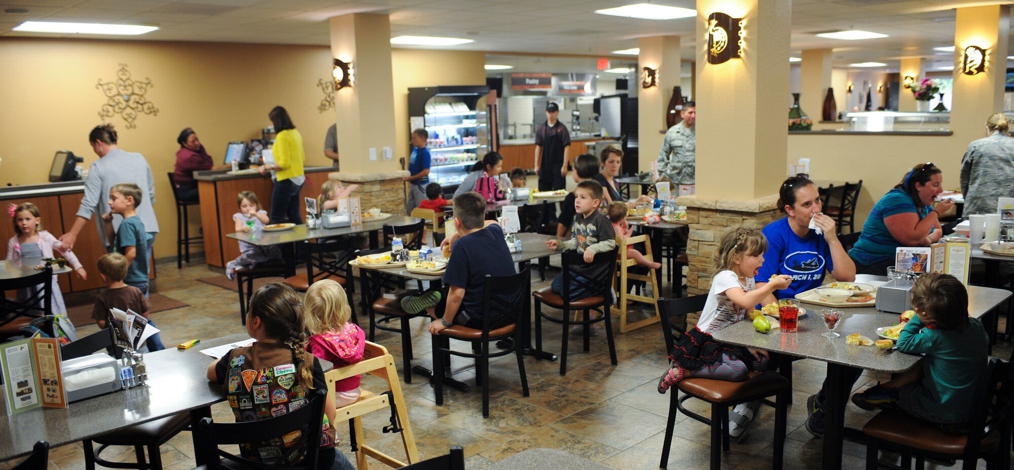Spouses and families of deployed Airmen have dinner during a deployed spouse’s event at Davis-Monthan Air Force Base, Ariz., April 3, 2014. More than 10 families attended the dinner and watched a movie at the Desert Inn Dining Facility. (U.S. Air Force photo by Senior Airman Sivan Veazie/Released)