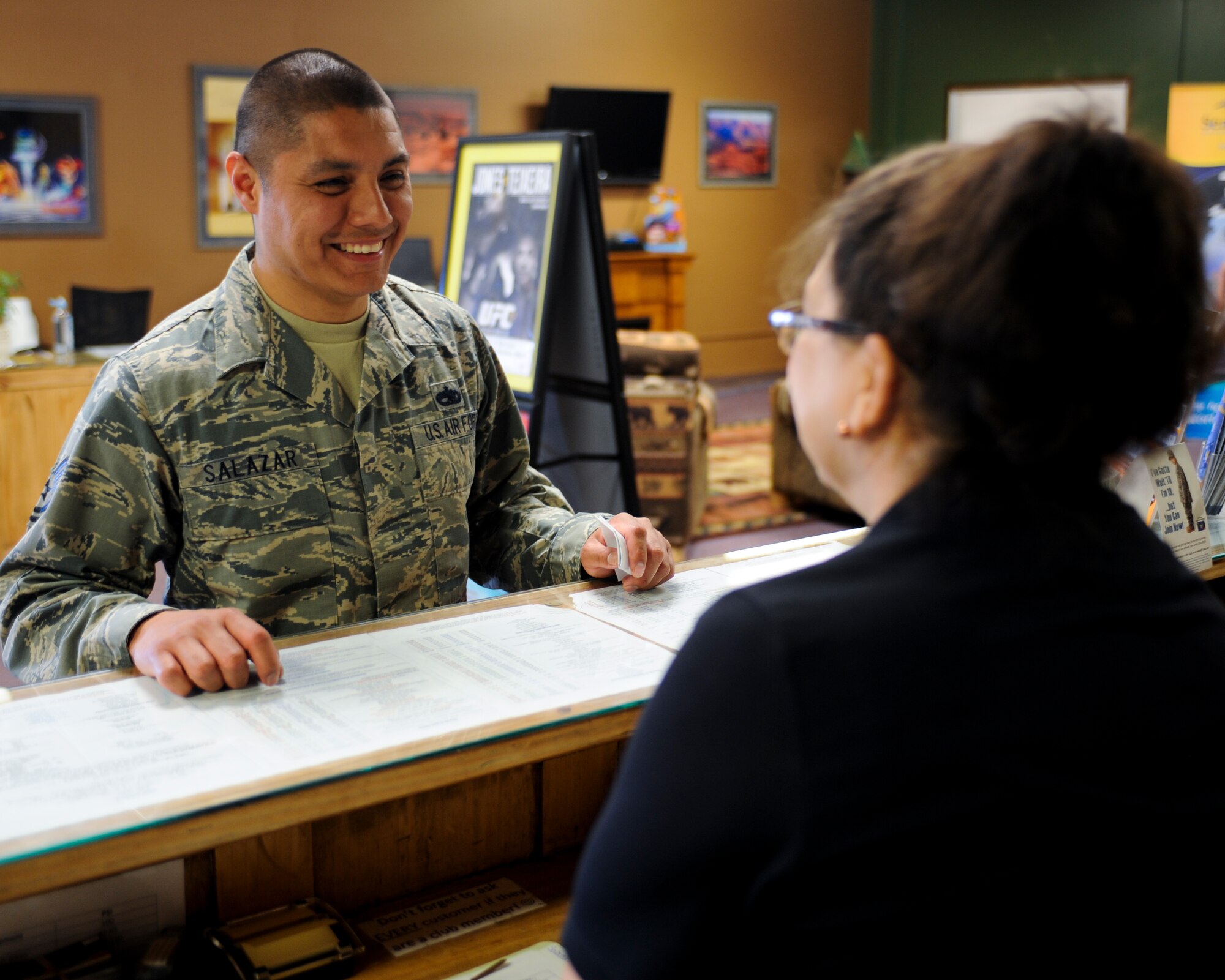 U.S. Air Force Tech. Sgt. Joseph Salazar, 355th Maintenance Group management operations center senior controller, talks to Linda Parker, 355th Force Support Squadron recreation assistant, about the different activities the Outdoor Recreation Center provides for Airmen at Davis-Monthan Air Force Base, Ariz., April 3, 2014. Some of the activities that the center provides include paintball, skeet and trap shooting and the indoor and outdoor swimming. (U.S. Air Force photo by Senior Airman Sivan Veazie/Released)