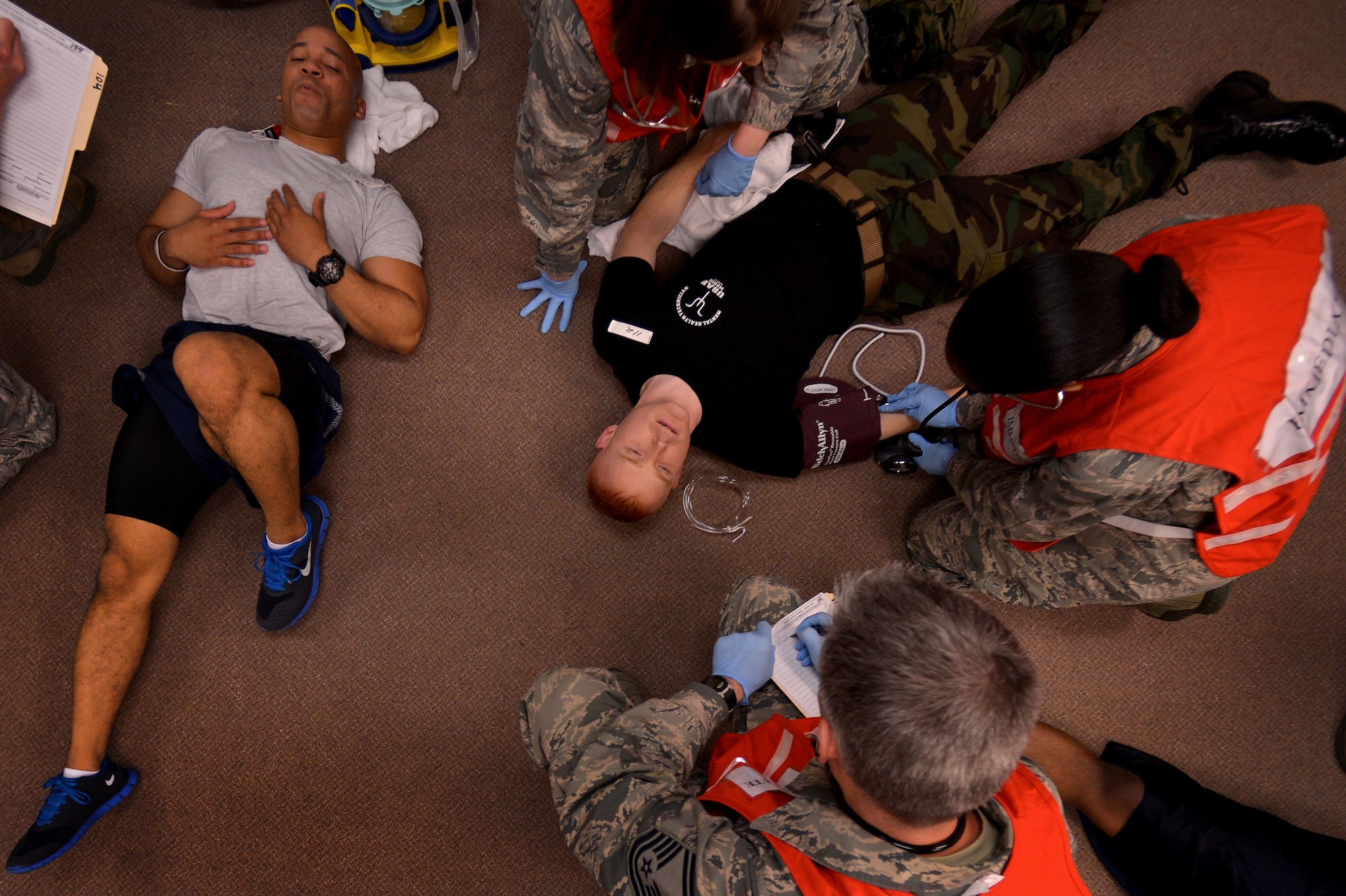 U. S. Air Force Airmen assigned to the 20th Medical Group aid victims of a simulated chemical and biological attack during a Mass Accident Response Exercise, April 4, 2014, Shaw Air Force Base, S.C. The 20th MDG conducted the exercise putting the entire group on high alert to test their ability to handle casualties. (U.S. Air Force photo by Staff Sgt. Kenny Holston/Released)