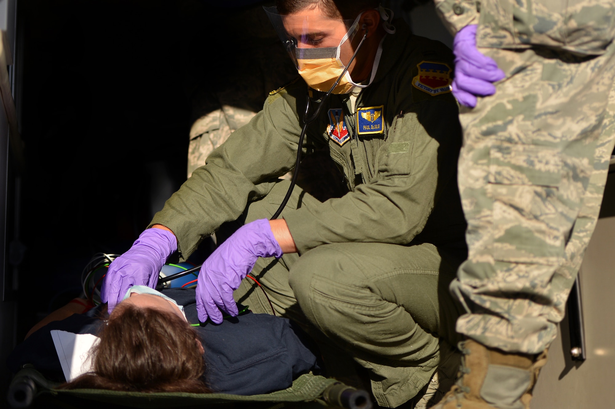 A U.S. Air Force Airman assigned to the 20th Medical Group aids a patient who was affected by a simulated chemical attack during a Mass Accident Response Exercise, April 4, 2014, Shaw Air Force Base, S.C. The 20th MDG holds exercises such as these during different times throughout the year to stay trained and prepared for real world situations. (U.S. Air Force photo by Staff Sgt. Kenny Holston/Released)