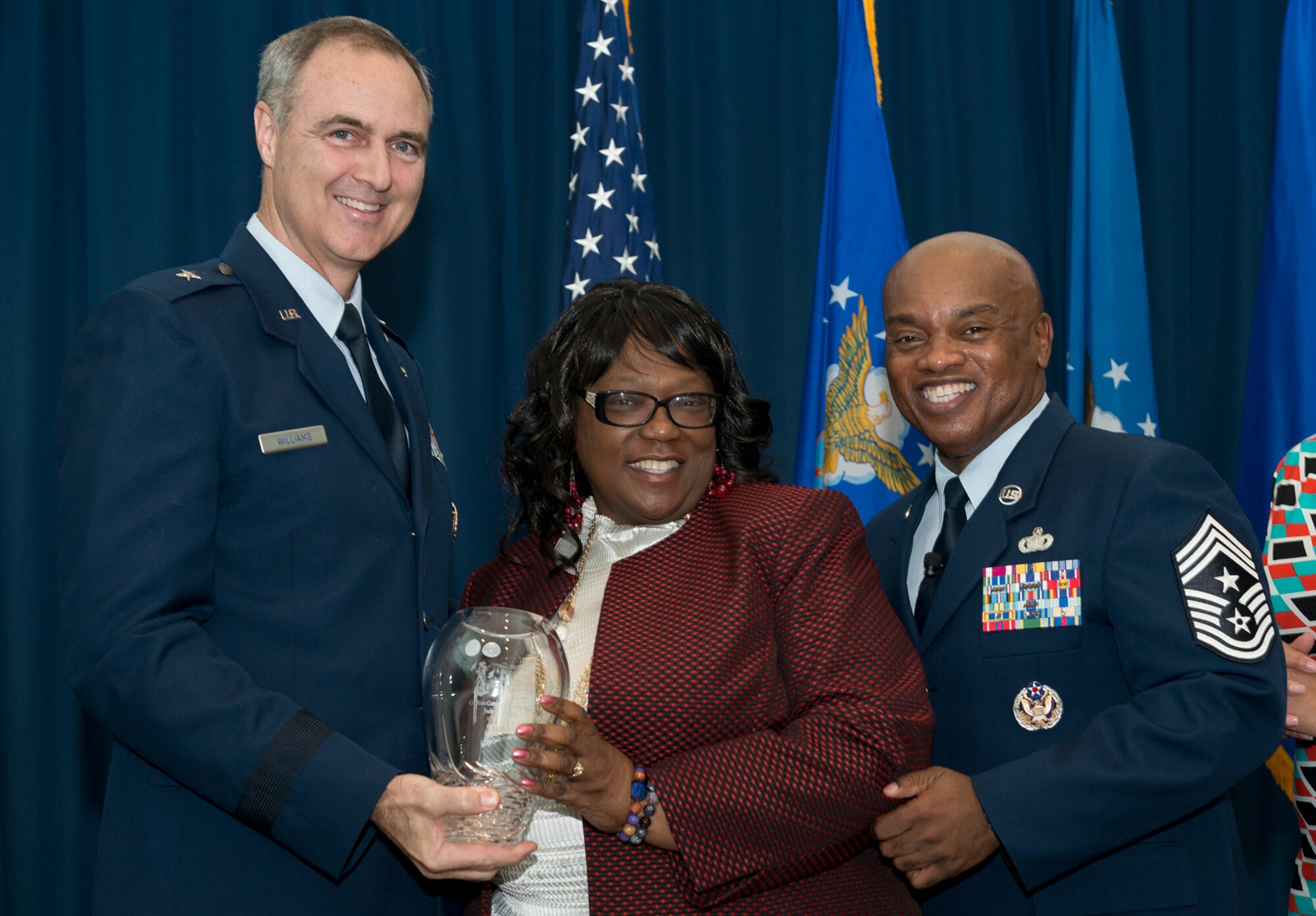 Brig. Gen. R. Scott Williams, the commander of the Air National Guard Readiness Center, and Chief Master Sgt. Tony L. Whitehead, the command chief master sergeant of the ANGRC, present the Civilian of the Year Category 2 award to Judy G. Rodgers, Operational Support and Compliance, during the ANGRC 2013 Annual Awards Ceremony April 4, 2014, at the ANGRC, Joint Base Andrews, Md. The ceremony hosted by Williams recognizes the accomplishments of the ANGRC staff. (U.S. Air National Guard photo by Master Sgt. Marvin R. Preston/RELEASED)