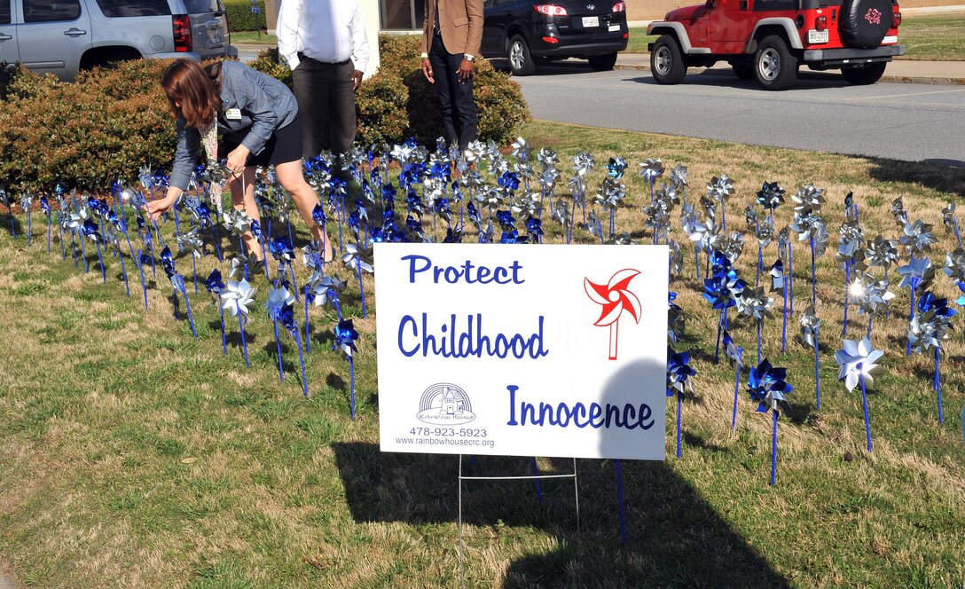 Attendees place pinwheels on Warner Robins City Hall’s front lawn Monday. The Pinwheels for Prevention Ceremony was part of the National Child Abuse Prevention Month kickoff, which included a proclamation signing. The pinwheel is the national symbol for child abuse and neglect prevention. (U.S. Air Force photo by Tommie Horton)