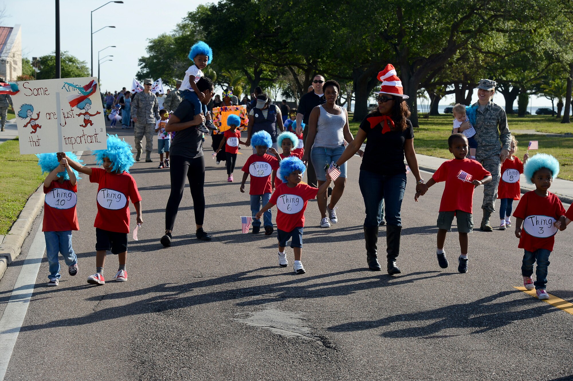 Children, parents and staff from the Child Development Centers walk in the Month of the Military Child parade April 3, 2014 at MacDill Air Force Base, Fla. Throughout the month of April, the centers will be hosting a calendar of events, to include an ice cream social, flight art auction, sidewalk chalk art walk, along with various spirit and themed days. (U.S. Air Force photo by Senior Airman Jenay Randolph/Released)