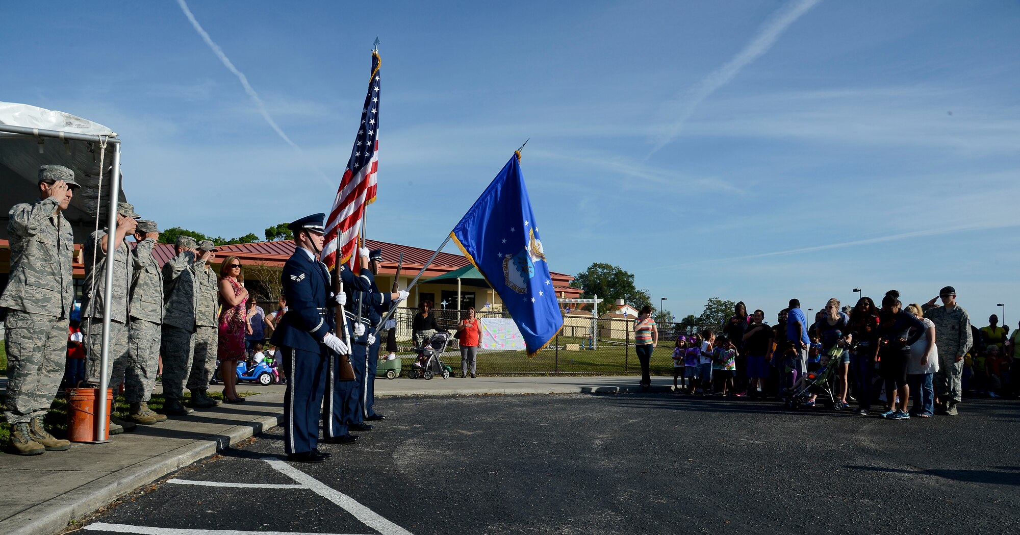 Members of the base honor guard post the colors to kick off the Month of the Military Child parade April 3, 2014 at MacDill Air Force Base, Fla. MOMC was established in 1986 by Caspar Weinberger, Secretary of Defense from 1981-1987, to recognize the contributions that military children make as their parents serve the country. (U.S. Air Force photo by Senior Airman Jenay Randolph/Released)