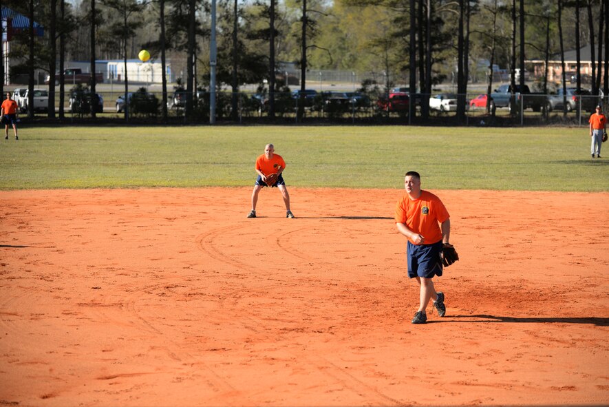 Airmen on the 20th Logistics Readiness Squadron softball team watches for the hit at Shaw Air Force Base, S.C., April 4, 2014. The 20th Mission Support Group held a day of team building events to help boost morale of Airmen. (U.S. Air Force photo by Airmen 1st Class Michael A. Cossaboom/Released)