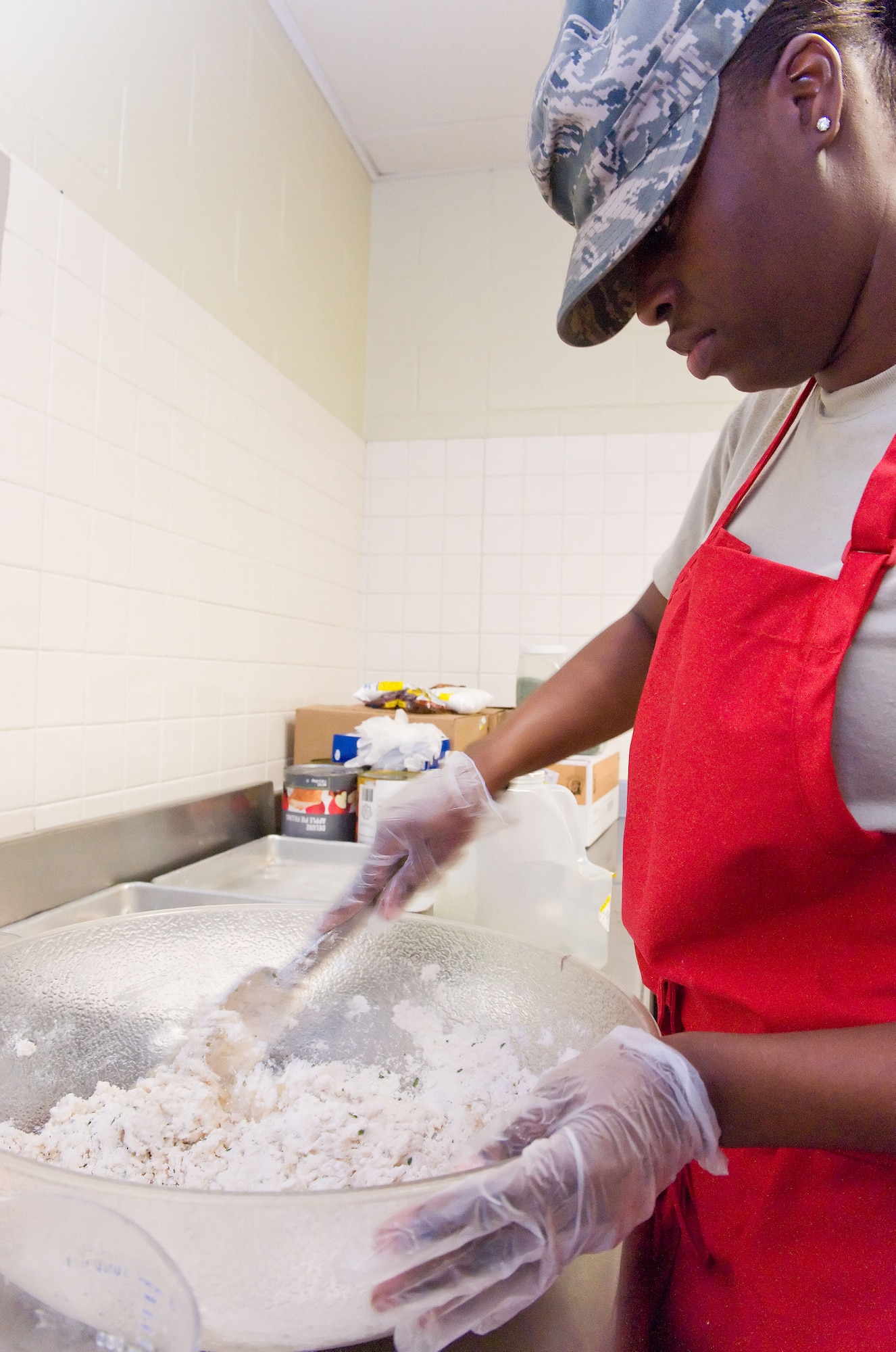 Tech. Sgt. Kenttrina Smith, 436th Force Support Squadron food service noncommissioned officer in charge, prepares a cheese biscuit recipe April 2, 2014, at the Patterson Dining Facility on Dover Air Force Base, Del. Smith made numerous batches of biscuit mix for the lunch hour snack line. (U.S. Air Force photo/Roland Balik)