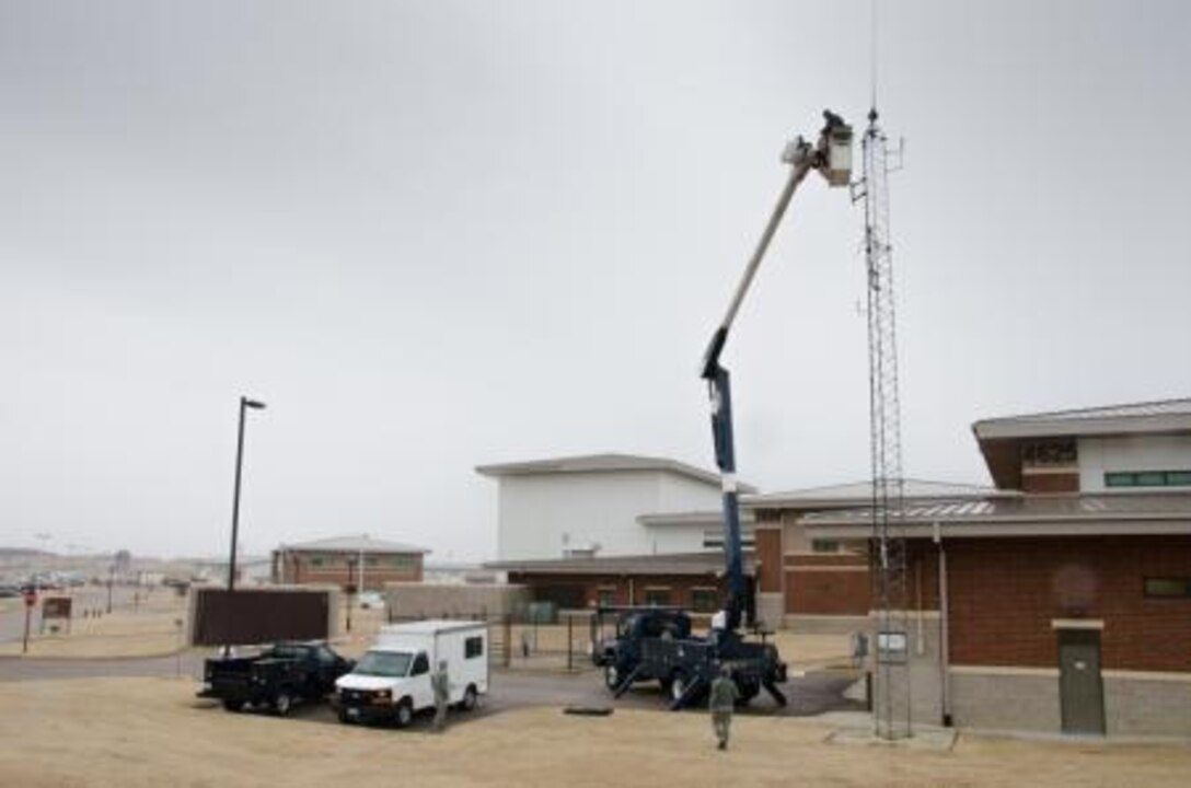 Members of the 164th Airlift Wing Communications Flight install a high frequency antenna at the Memphis Air Guard Base, Tenn., Jan. 31, 2014. The antenna gives the 164th the ability to operate on the state emergency management system. (Air National Guard photo by Master Sgt. Danial Mosher/released)