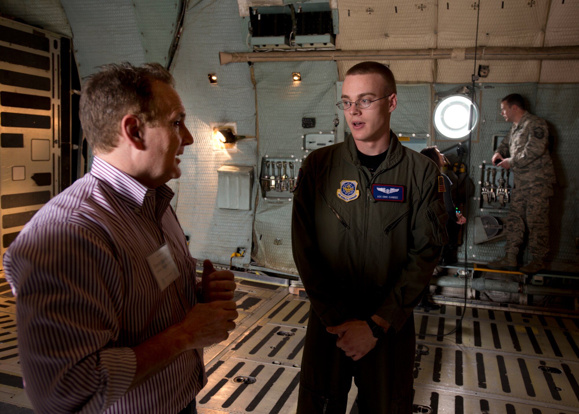 Emory Lunsford, a member of the Joint Base Lewis-McChord, Wash., civic leaders group asks Airman 1st Class Eric J. Candee, 22nd Airlift Squadron C-5 Galaxy loadmaster journeyman, about his duties. The civic leaders were treated to a line-of-fire demonstration by the 621st Contingency Response Wing as well as a tour of the control tower and static displays of the KC-10 Extender and C-5 aircraft during their visit. (U.S. Air Force photo by T.C. Perkins Jr.)