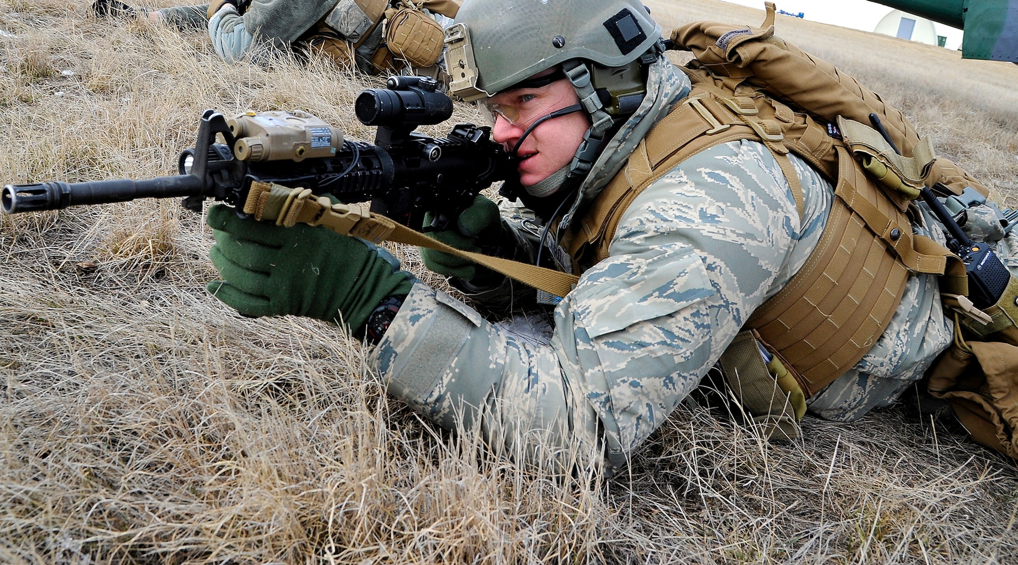 Senior Airman Kevin Carroll, 341st Security Forces Group Tactical Response Force assaulter, scans his field of view while practicing an infiltration exercise with his team at the Warrior Launch Facility trainer March 25. Carroll and his team set up what is known as a “wedge” in the TRF community, which is a defensive perimeter used to protect incoming or outgoing aircraft from their position. (U.S. Air Force photo/Airman 1st Class Collin Schmidt)