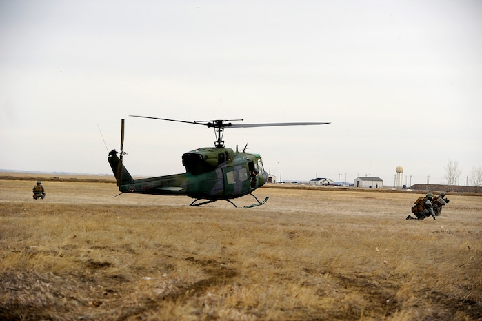 Members from the 341st Security Forces Group Tactical Response Force practice combat maneuvers during a training session at the Warrior Launch Facility trainer March 25. During the training, the team practiced entering and exiting a combat zone via Malmstrom’s UH-1N Huey helicopters. (U.S. Air Force photo/Airman 1st Class Collin Schmidt)