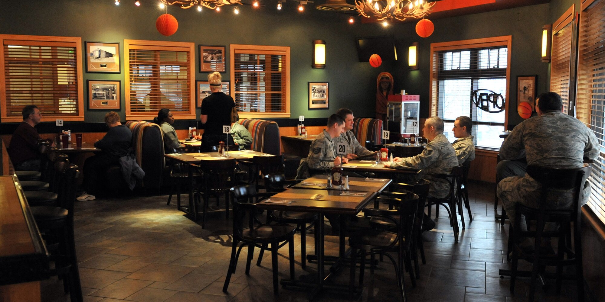 Service members and civilians eat at the Grizzly Bend on April 1 for the grand opening of Grizzly Bend’s new lunch and dinner venue. The Grizzly Bend is now serving lunch and dinner Monday 11 a.m. to 2 p.m., Tuesday through Thursday 11 a.m. to 7 p.m. and Friday 11 a.m. to 9 p.m. Stop by and check out their new menu, which includes appetizers, salads, soups, sandwiches, entrees and desserts. (U.S. Air Force photo/Airman 1st Class Joshua Smoot)