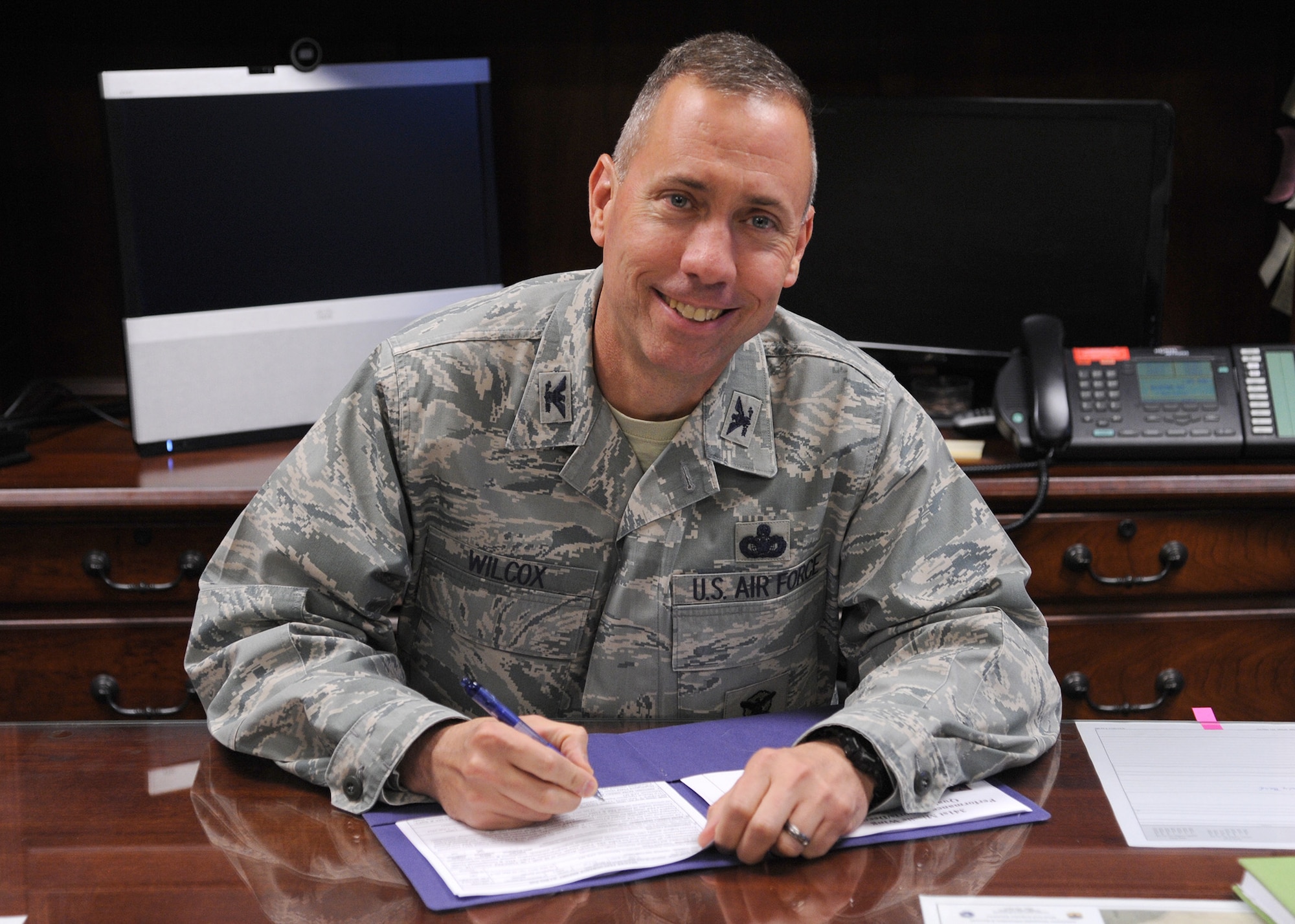 Col. Tom Wilcox, 341st Missile Wing commander, finishes up some paperwork at his desk April 1. Wilcox started his career at Malmstrom Air Force Base as a flight leader and is “glad to be back,” he said. (U.S. Air Force photo/Senior Airman Cortney Paxton)