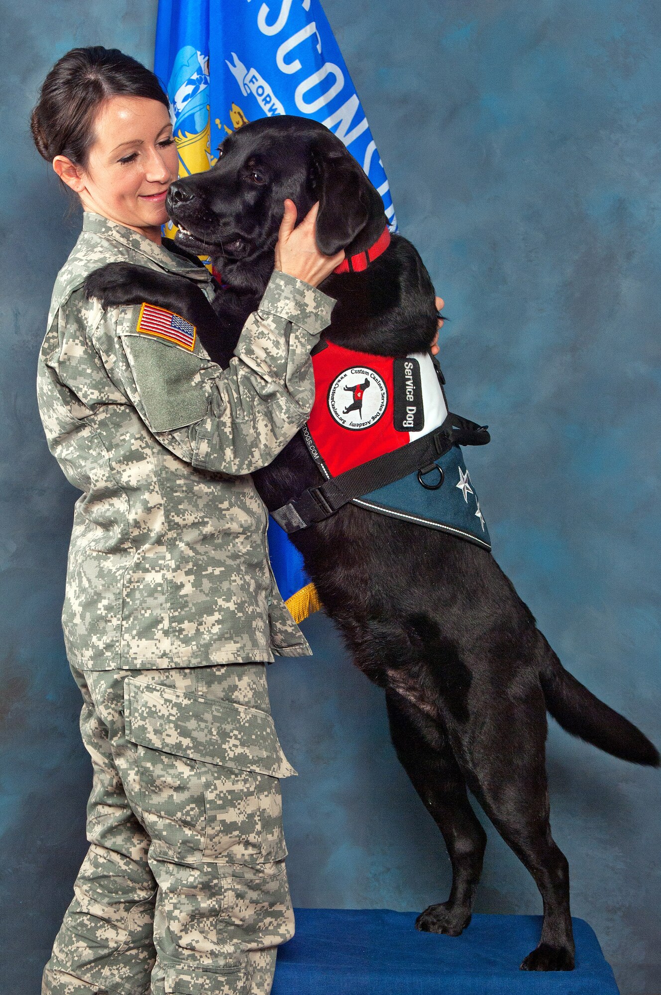 Working dog Falcon, with 2nd Lt. Amber Garfoot, is assigned to the Wisconsin National Guard as a vital member of the Sexual Assault Prevention and Response team. Falcon's presence helps put victims of sexual or physical assault more at ease, which in turn makes future visits to discuss a traumatic subject more tolerable. (Photo by Vaughn R. Larson )