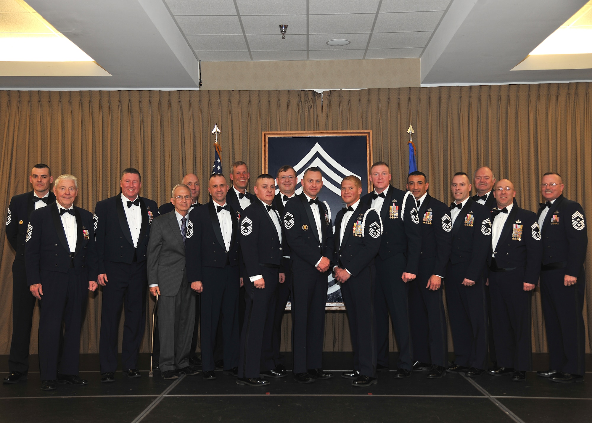 Retired Chief Master Sgt. Robert Gaylor (left) and Chief Master Sgt. David Duncan, 319th Air Base Wing command chief (right) stand with current and retired chief master sergeants during a recognition ceremony held March 28, 2014, at the Northern Lights Club on Grand Forks Air Force Base, N.D. Gaylor became the fifth Chief Master Sergeant of the Air Force in 1977 and was the guest speaker at the event. (U.S. Air Force photo/Senior Airman Xavier Navarro)