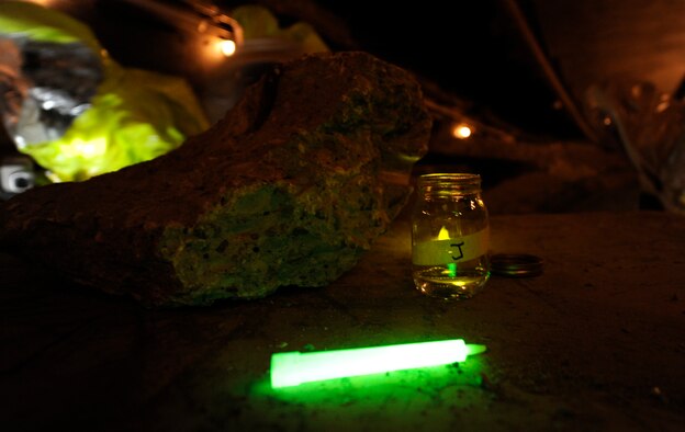 Civil Engineering Airmen use glow sticks to mark jars filled with active chemical agents during a Black Flag training exercise at the Center for National Response in W.Va., March 27, 2014. The student Airmen must track their findings for the next team to follow and test what types of agents they are working with. (U.S. Air Force Photo/ Airman 1st Class Nesha Humes)