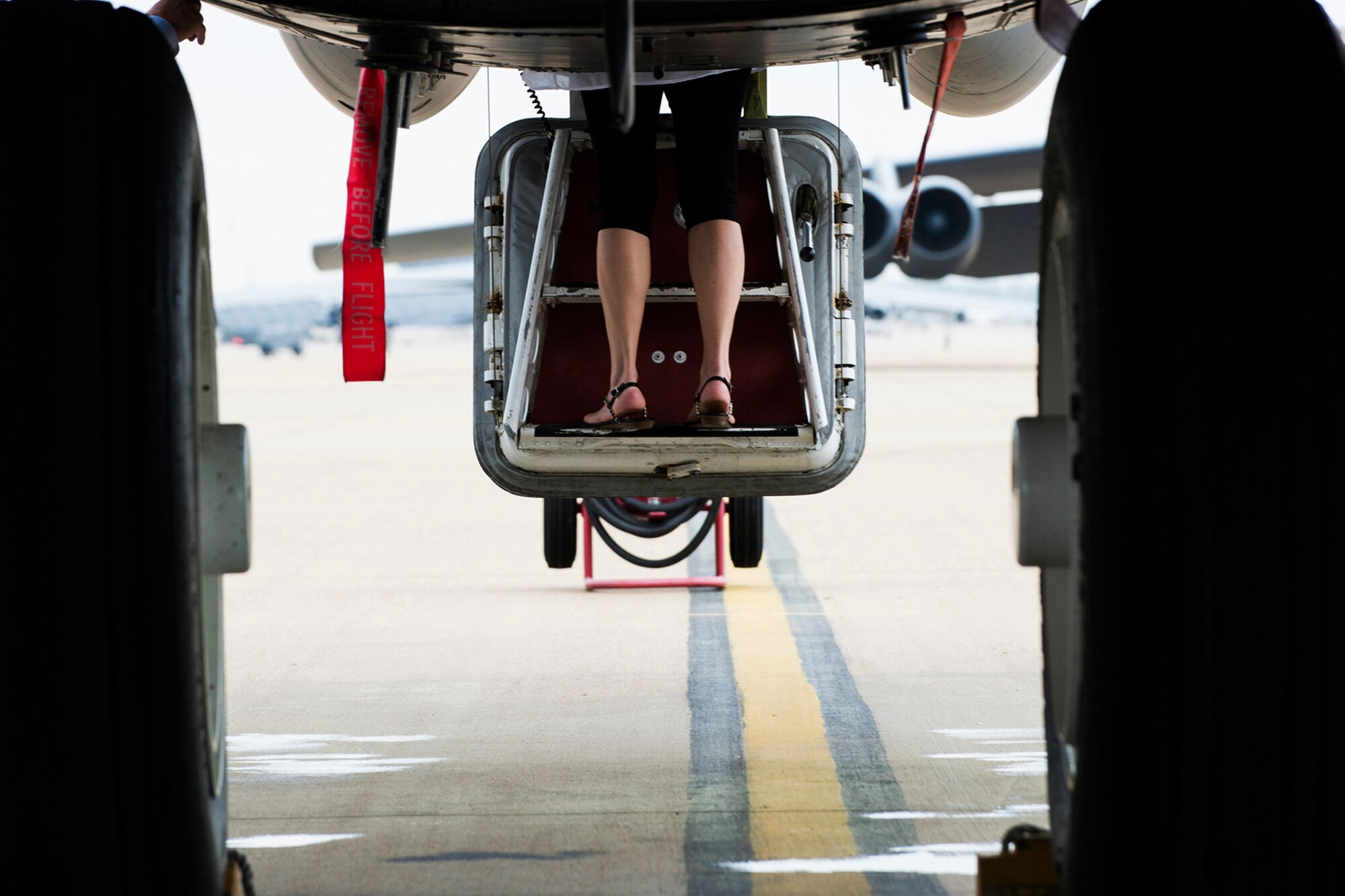 A family member of a Formal Training Unit (FTU) graduate makes her way up the hatch of a B-52H Stratofortress following a ceremony held on April 2, 2014, Barksdale Air Force Base, La. The FTU is comprised of the 93rd and 11th Bomb Squadrons, and provides initial qualification training on the B-52 to future pilots, navigators and electronic warfare officers. (U.S. Air Force photo by Master Sgt. Greg Steele/Released)