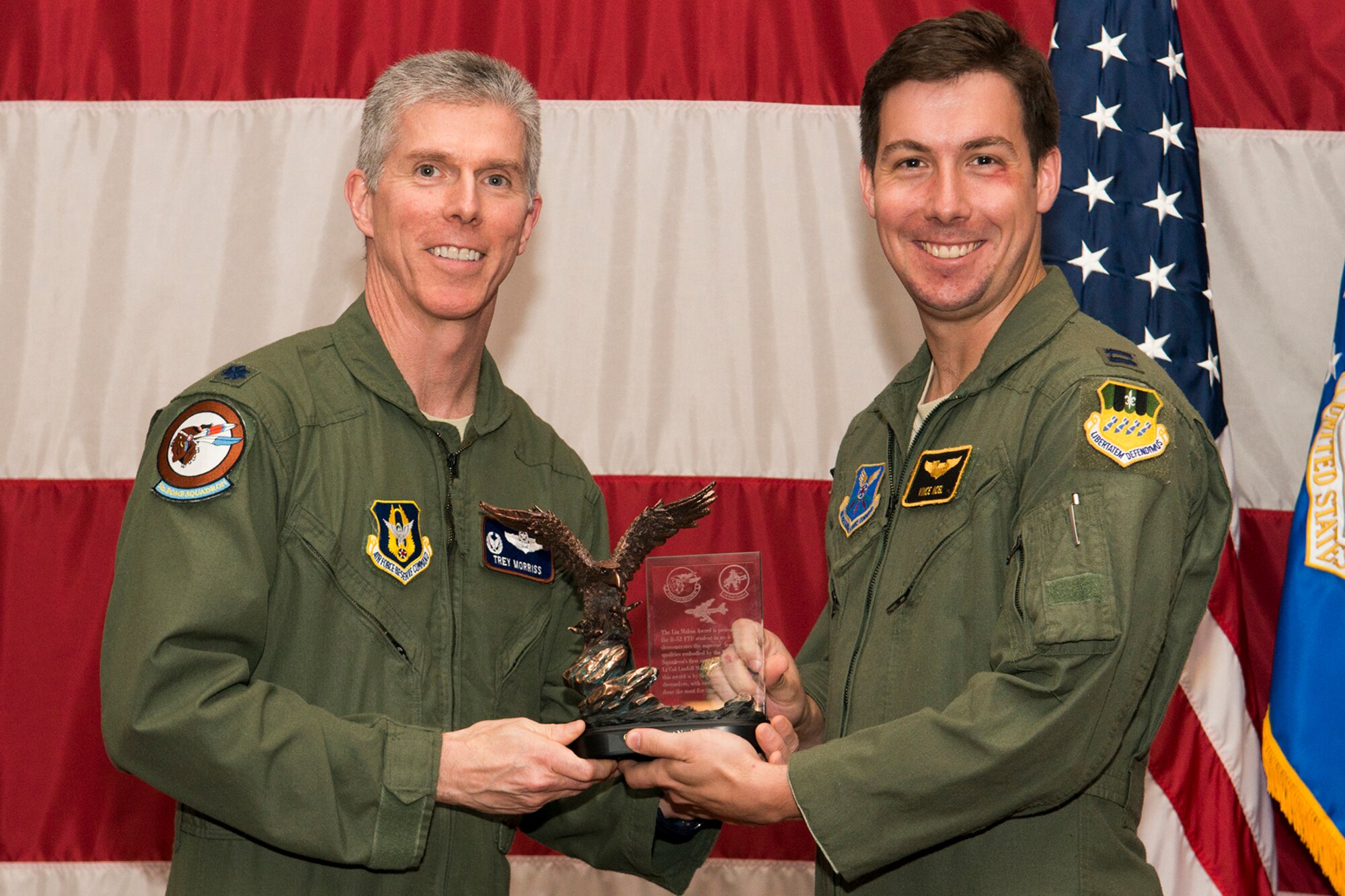 U.S. Air Force Lt. Col. James Morriss, 93rd Bomb Squadron commander, presents the Lindell Mabus Leadership Award to Capt. Vincent Noel during a B-52 Formal Training Unit graduation ceremony, April 2, 2014, Barksdale Air Force Base, La. Noel was selected by his fellow classmates for his exceptional leadership which was critical to the class's graduation. (U.S. Air Force photo by Master Sgt. Greg Steele/Released)