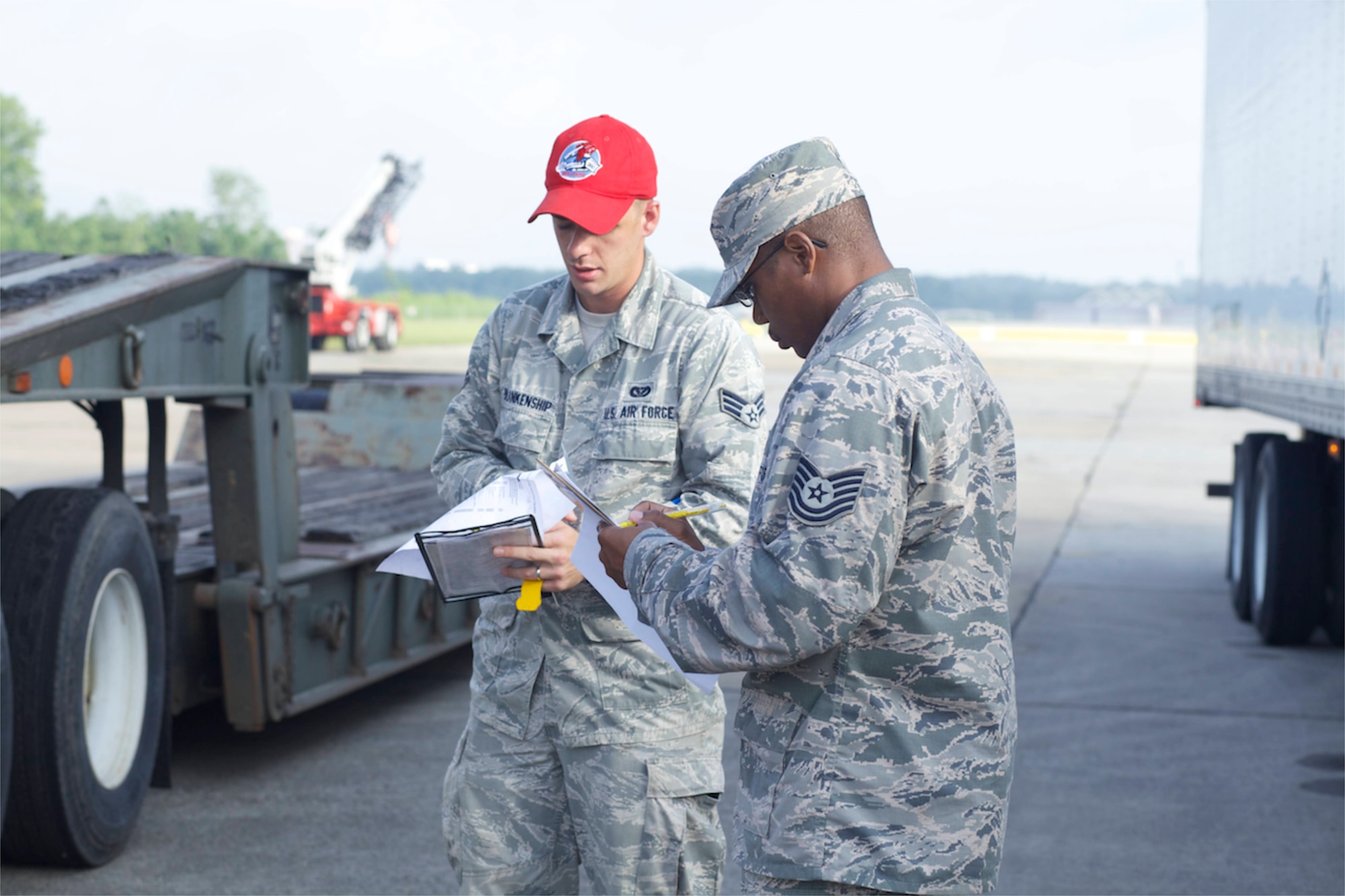 Tech. Sgt. Alexes Abrams (right), 622nd Civil Engineer Group, an instructor for the tractor trailer “train the trainer," or 3T, course at the Expeditionary Combat Support Training Certification Center, Dobbins Air Reserve Base, Ga., goes over pre-trip inspection paperwork with a student, Senior Airman Michael Blankenship, 560th Red Horse Squadron Joint Base Charleston, S.C. The 80-hour, total force course is also being offered at Fort Indiantown Gap, Penn. (U.S. Air Force photo/Eddie Green)