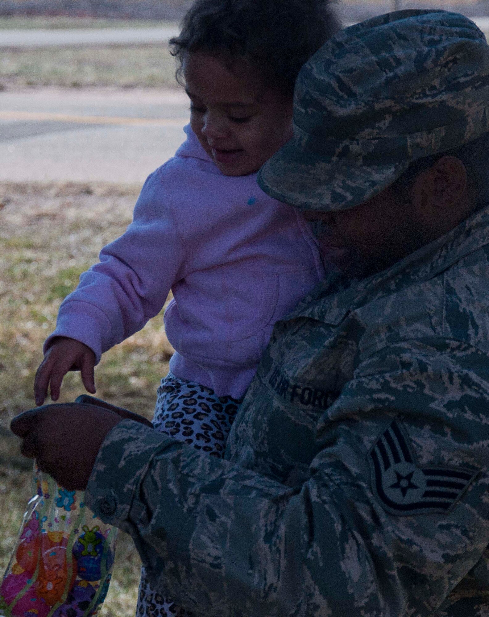 140402-F-GZ967-031 Staff Sgt. Dorian Howard, Air Force Global Strike Command missile engineer, helps Nakaia Howard, 3, during an Easter egg hunt April 2 at the Easter Egg-stravaganza event. Children were split by age group and released outside to search for eggs outside of the Arts and Crafts Center. (U.S. Air Force photo by Airman 1st Class Brandon Valle)