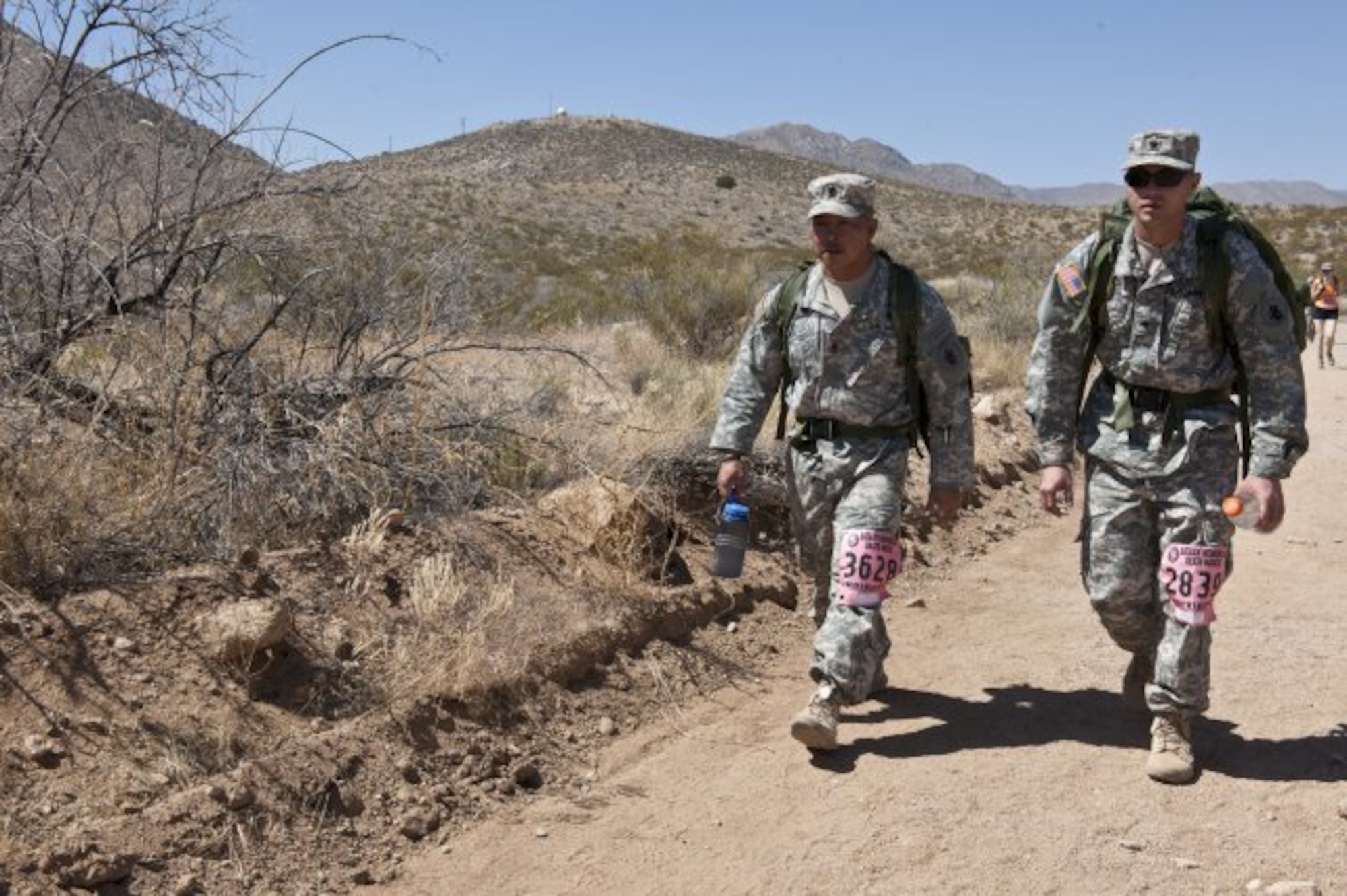 First Sgt. Thinh Huynh (left) and Spc. Christopher Floyd, both assigned to U.S. Army South's Joint Task Force-Bravo, march through the desert during the 25th Bataan Memorial Death March at White Sands Missile Range, New Mexico March 23, 2014. The Bataan Memorial Death March honors a group of World War II heroes, who defended the islands of Luzon, Corregidor and the harbor defense forts of the Philippines in 1942. After being captured by the Japanese forces, these Army, Army Air Corps, Navy, Marines, and National Guard heroes, survived on half or quarter rations and outdated equipment during the 80 mile march.The soldiers were responsible for the defense of the islands of Luzon, Corregidor and the harbor defense forts of the Philippines. (Courtesy photo)
