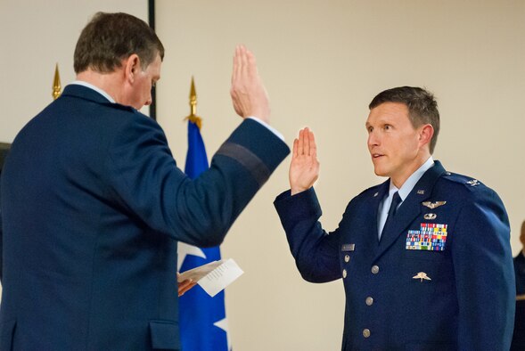 Kentucky’s adjutant general, Maj. Gen. Edward Tonini (left), executes the Oath of Office during a ceremony promoting Jeffrey Wilkinson to the rank of colonel at the Kentucky Air National Guard Base in Louisville, Ky., March 22, 2014. Wilkinson, vice commander of the 123rd Airlift Wing, is the first special tactics officer to be promoted to the rank of colonel in Kentucky Air Guard history. (U.S. Air National Guard photos by Staff Sgt. Vicky Spesard)