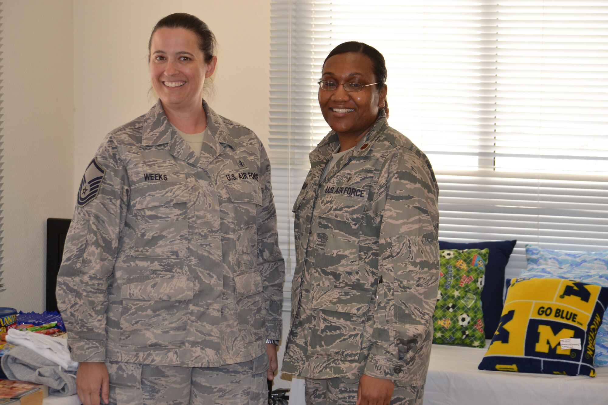 Master Sgt. Allison Weeks, the 379th Expeditionary Medical Operations Squadron, Mental Health Clinic outpatient services flight chief, and Maj. Michelle Gramling, clinical social worker, pose during the MHC open house at Al Udeid Air Base, March 30, 2014.  A variety of free quality of life items were donated from the Landstuhl Hospital Care Project, amounting to about $20,000, were offered to service members in an effort to help boost morale and bring a face to the services offered by the MHC.   Weeks is deployed from Eielson Air Force Base, Alaska and a Palmer, Alaska native.  Gramling is stationed at Shaw Air Force Base, S.C., and a native of Columbia, S.C.  (U.S. Air Force Photo by Maj. Nicole David)