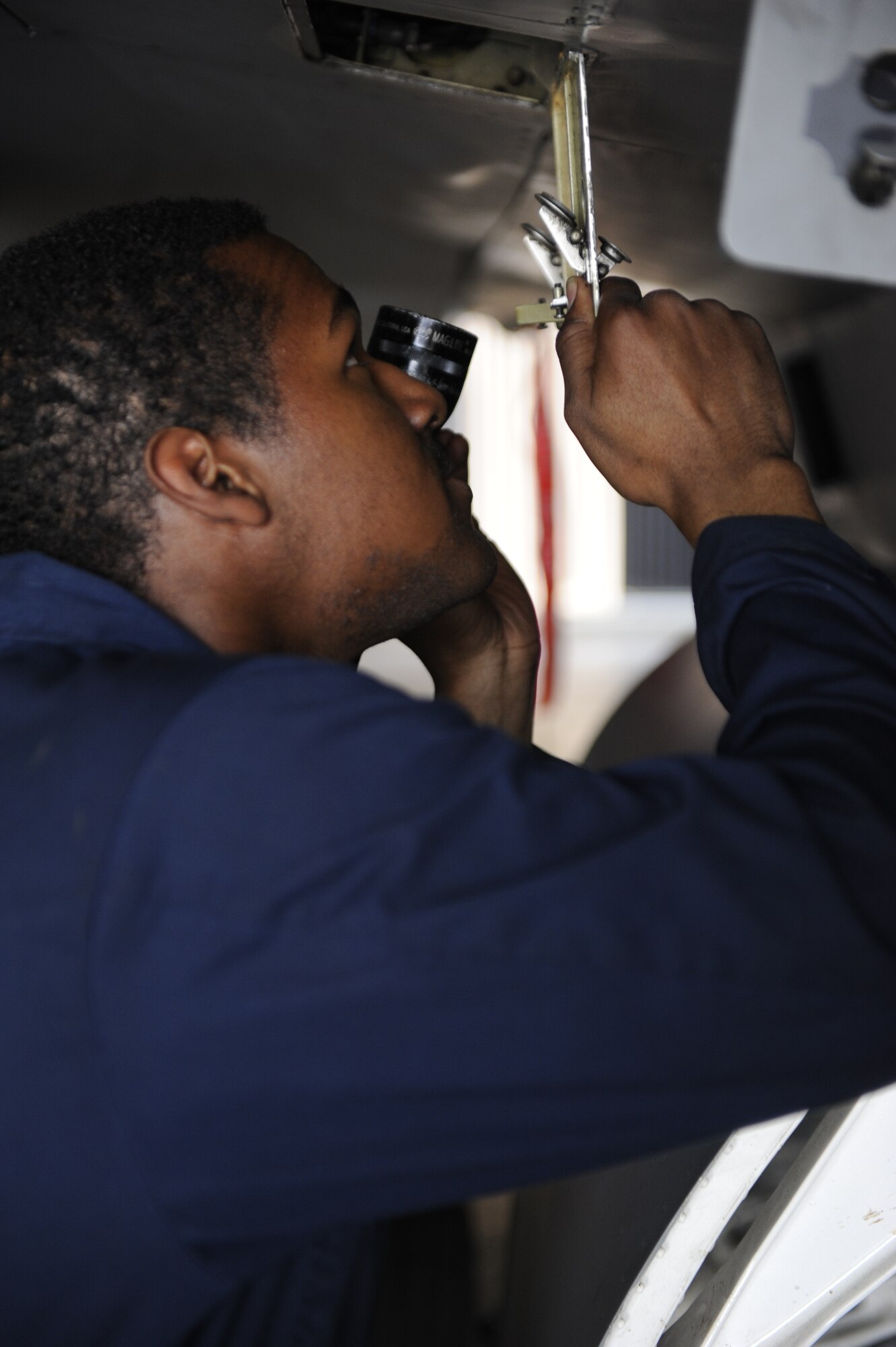 Senior Airman Saeed Oglesby, 8th Aircraft Maintenance Squadron, 80th Aircraft Maintenance Unit assistant dedicated crew chief, conducts checks prior to take off at Kunsan Air Base, Republic of Korea, Apr. 3, 2014. Crew chiefs are responsible for the maintenance and inspection of the aircraft, as well as conducting several overall checks of the aircraft before the pilot arrives for the launch. (U.S. Air Force photo by Staff Sgt. Jessica Haas/Released)