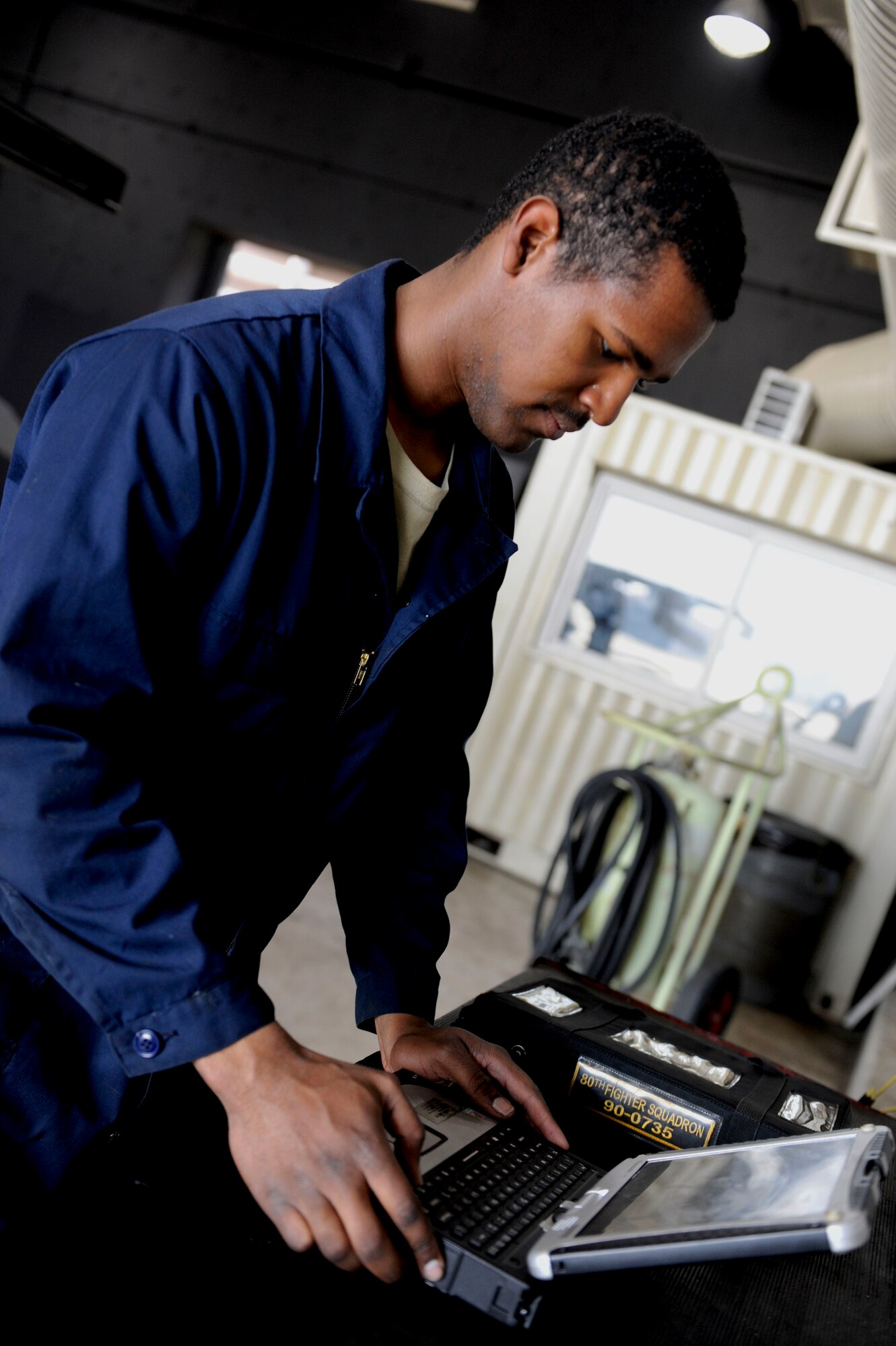 Senior Airman Saeed Oglesby, 8th Aircraft Maintenance Squadron, 80th Aircraft Maintenance Unit assistant dedicated crew chief, reviews necessary documents prior to take off at Kunsan Air Base, Republic of Korea, Apr. 3, 2014. Crew chiefs are responsible for the maintenance and inspection of the aircraft, as well as conducting several overall checks of the aircraft before the pilot arrives for the launch. (U.S. Air Force photo by Staff Sgt. Jessica Haas/Released)