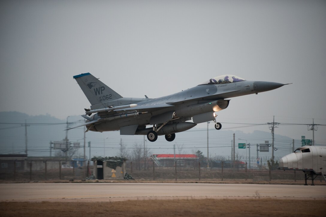 A 35th Fighter Squadron F-16 lands on the Alternate Landing Surface at Kunsan Air Base, Republic of Korea, Mar. 19, 2014. The ALS was activated and utilized to test the Wolf Pack's ability to land aircraft in the event that the primary runway is unavailable. (U.S. Air Force photo by Staff Sgt. Clayton Lenhardt/Released)