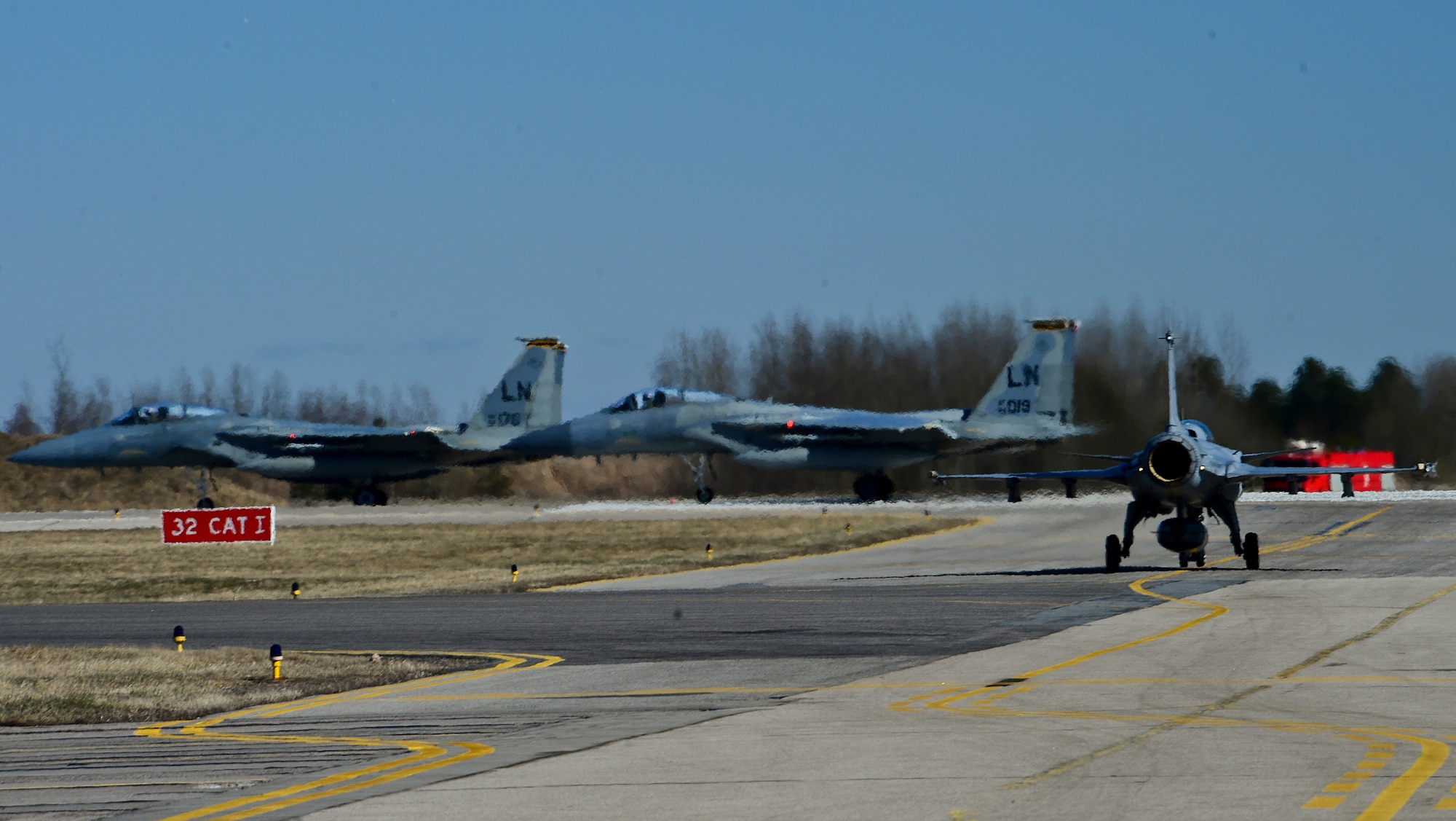 A Swedish air force JAS-39 Gripen taxis to the runway following two F-15C Eagles during the 17th Baltic Region Training Event at Šiauliai Air Base, Lithuania, April 1, 2014. The event took place in the skies over the Baltic Region to sharpen skills of aircrews and air controllers from the U.S., Lithuanian and Swedish air forces. The event is designed to offer training opportunities for the enhancement of interoperability between allied partners. (U.S. Air Force photo by Airman 1st Class Dana J. Butler/Released)