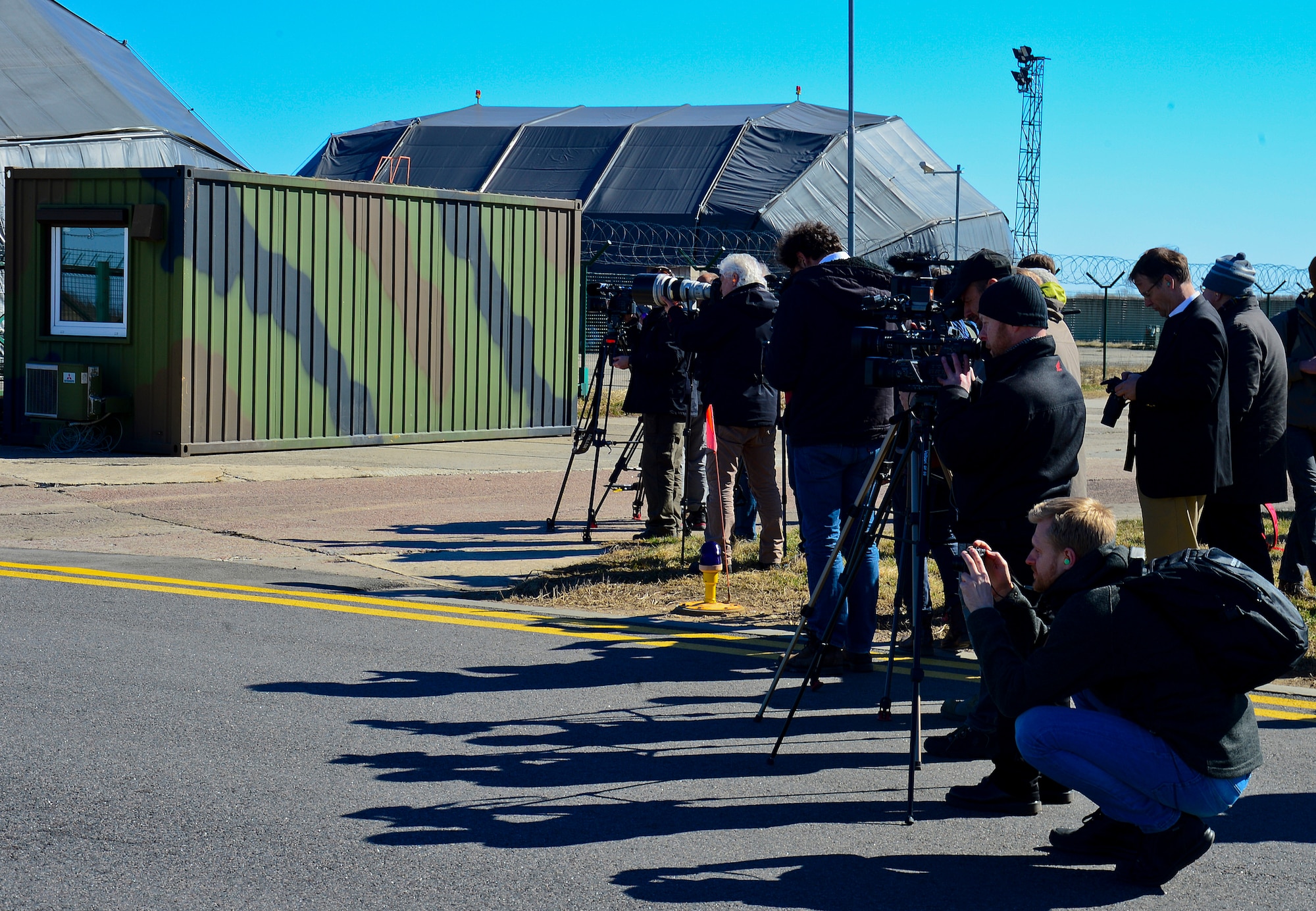 Local and international media watch as U.S. Air Force F-15C Eagles and Swedish air force JAS-39 Gripens take off during the 17th Baltic Region Training Event at Šiauliai Air Base, Lithuania, April 1, 2014. The event took place in the skies over the Baltic region to sharpen the skills of aircrews and air controllers from the U.S., Lithuanian and Swedish air forces. The event is designed to enhance the interoperability between allied partners in NATO and its Partnership for Peace program. (U.S. Air Force photo by Airman 1st Class Dana J. Butler/Released)