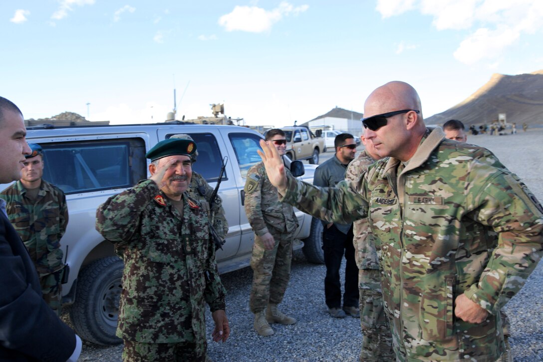 U.S. Army Lt. Gen. Joseph Anderson, right, commander of the International Security Assistance Force Joint Command, wraps up an election meeting with Afghan army Maj. Gen. Mohammad Yaftali, commander of the 203rd Corps on Forward Operating Base Thunder in Afghanistan's Paktia province, April 2, 2014.