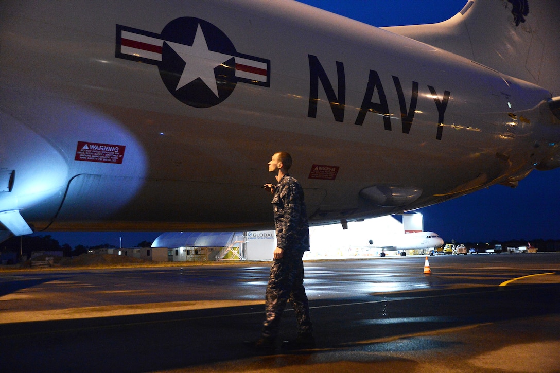 U.S. Navy Petty Officer 3rd Class Justin Kaiser checks the structural integrity of a P-8A Poseidon aircraft in Perth, Australia, April 1, 2014, before assisting in the search for Malaysia Airlines Flight 370. Kaiser is an aviation machinist's mate assigned to Patrol Squadron 16.