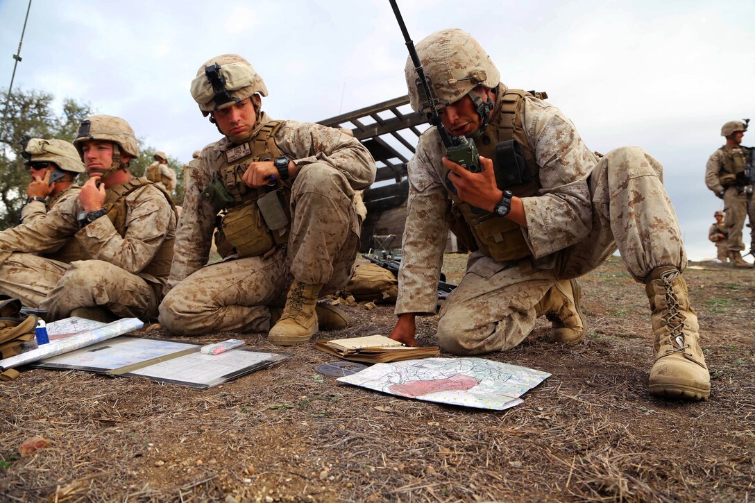 Marines establish communication with Charlie Battery, the artillery unit for 11th Marine Expeditionary Unit, as part of a tactical exercise during Realistic Urban Training Marine Expeditionary Unit Exercise 14-1, on Fort Hunter Liggett, Calif., March 25, 2014. The Marines are assigned to Echo Company, Battalion Landing Team, 2nd Battalion, 1st Marines, 11th Marine Expeditionary Unit. During the training, Fox Company, Echo Company and Combined Anti-armor Team coordinated target points with Charlie Battery.