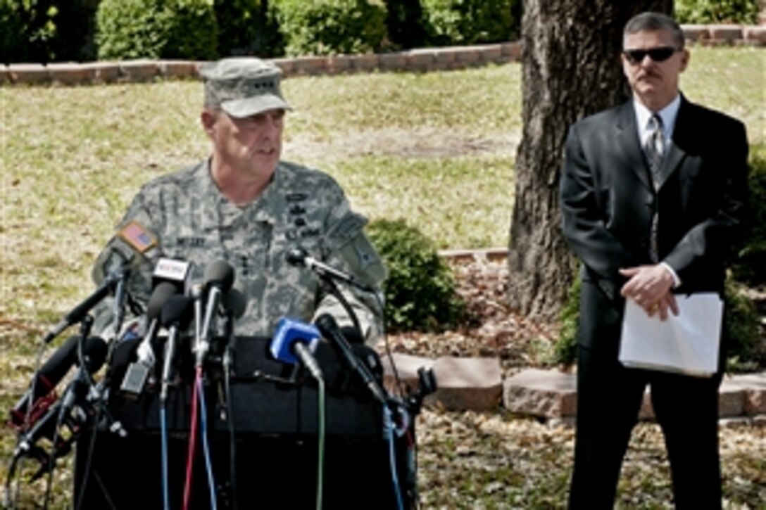 Army Lt. Gen. Mark A. Milley updates reporters on Fort Hood, Texas, April 4, 2014, about the April 2 shooting on base as Chris Grey, the chief of public affairs/media for U.S. Army Criminal Investigation Command at Quantico, Va., looks on. Milley is the base's commander and Grey also is the spokesperson for the law enforcement task force leading the investigation. During the incident, a soldier killed three others and wounded 16 before taking his own life.