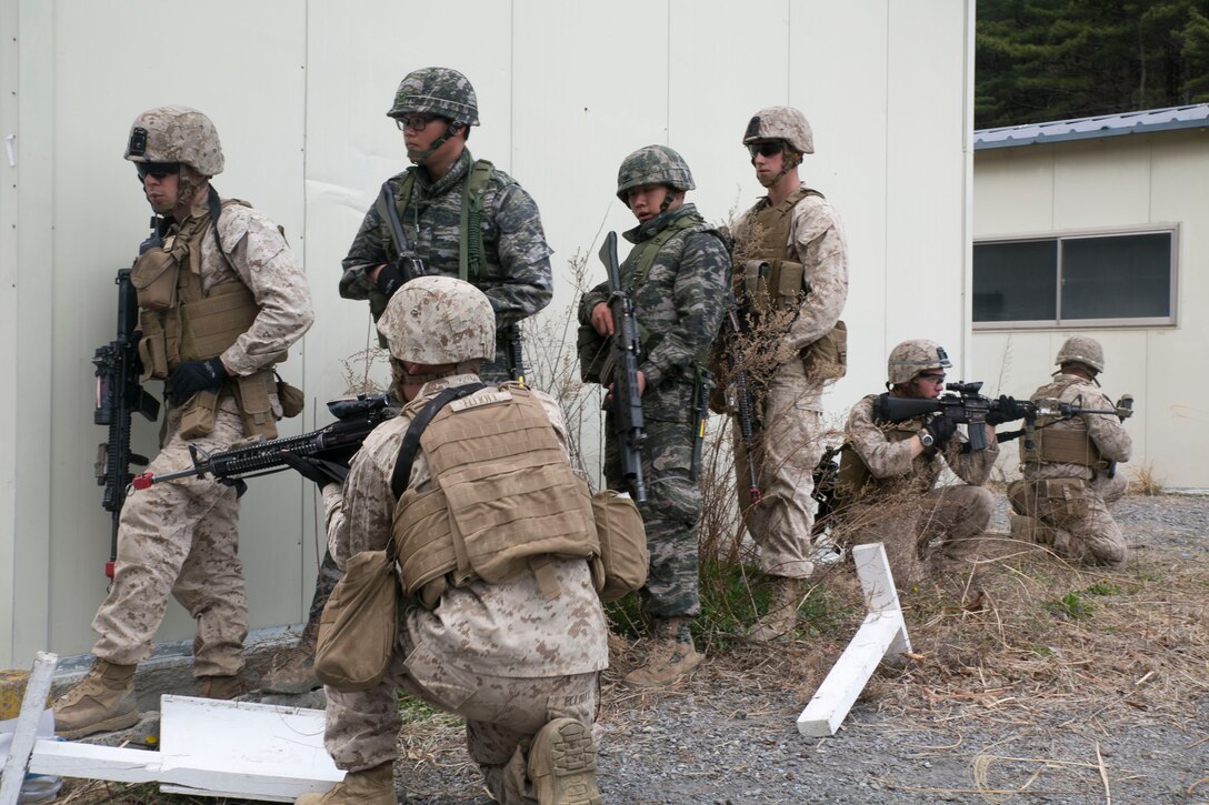 Republic of Korea and U.S. Marines stack against a wall and await the order to advance while conducting vertical assaults April 2 during Ssang Yong 14 at an abandoned training range in Pohang, Republic of Korea. Ssang Yong 14 exercises the combined capability of ROK and U.S. Navy and Marine Corps forces. . The ROK Marines pictured are with 3rd Battalion, 7th Regiment, 1st ROK Marine Division. The U.S. Marines are with 2nd Battalion, 3rd Marine Regiment, 3rd Marine Division. (U.S. Marine Corps photo by Lance Cpl. Cedric R. Haller II/RELEASED)