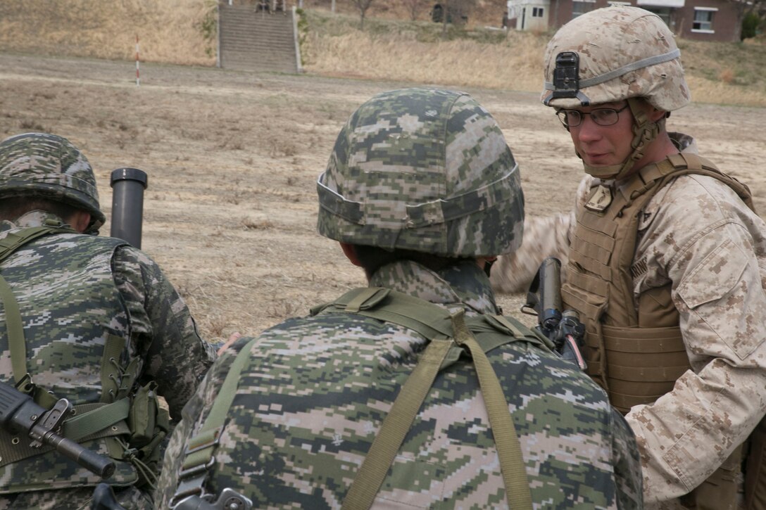 Republic of Korea Marines receive instruction from a U.S. Marine on different mortar techniques on providing supporting fire for Marines conducting vertical assaults April 2 during Ssang Yong 14 at an abandoned training range in Pohang, Republic of Korea. Military relationships between the U.S. and partner nations are critical to maintaining balance and efficiency across the globe. The ROK Marines pictured are with 3rd Battalion, 7th Regiment, 1st ROK Marine Division. The U.S. Marine is with 2nd Battalion, 3rd Marine Regiment, 3rd Marine Division. (U.S. Marine Corps photo by Lance Cpl. Cedric R. Haller II/RELEASED)