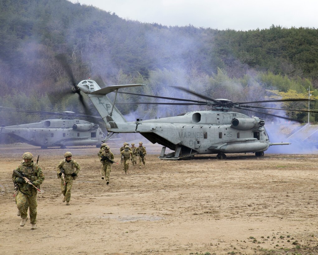 Australian soldiers run out of a CH-53E Super Stallion April 4 in Pohang, Republic of Korea as part of a simulated vertical assault. The Australians assaulted a wooded area after disembarking and used techniques learned from U.S. Marines to clear the area defended by U.S. Marines. The soldiers are with 6th Battalion, Royal Australian Regiment, Royal Australian Army. (U.S. Marine Corps photo by Cpl. Lena Wakayama/Released)