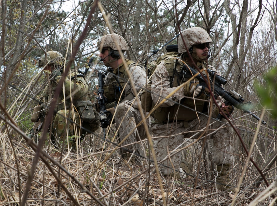 An Australian soldier and U.S. Marines pause in the woods as they choose their next course of action April 4 in Pohang, Republic of Korea. The soldiers and Marines conducted a simulated vertical assault with the objective of clearing the area of opposing forces, hidden throughout the area. The soldiers are with 6th Battalion, Royal Australian Regiment, Royal Australian Army, and the Marines are with 2nd Battalion, 3rd Marine Regiment, 3rd Marine Division, III Marine Expeditionary Force. (U.S. Marine Corps photo by Cpl. Lena Wakayama/Released)