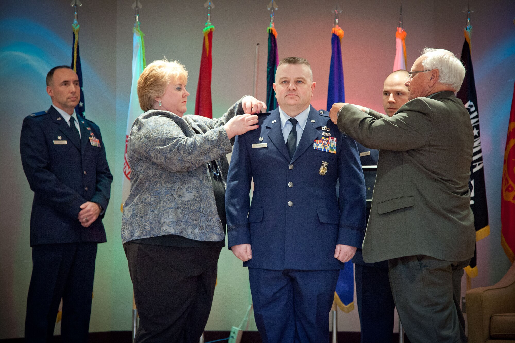 Col. Bryan Anders, 934th Civil Engineering Squadron commander, has his new rank pinned on him by his wife, Shelly Anders, and father, Gerald Anders, at his promotion ceremony during the April Unit Training Assembly weekend at the Minneapolis-St. Paul Air Reserve Station, Minn.  (U.S. Air Force photo by Shannon McKay/Released)